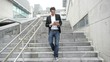 Man walking down stairs with tablet Man walking down stairs with tablet
