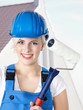 Pretty construction worker trainee in front of building lot