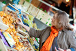 Beautiful woman buying mushrooms at market