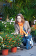 Beautiful girl buying flowers at market