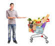 Man gesturing and shopping cart full of groceries