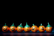 Orange pumpkin wrapped chocolatesin a row