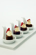 Chocolate brownie Dessert on white porcelain tasting spoons