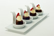 Chocolate brownie Dessert on white porcelain tasting spoons