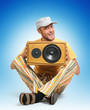 Party man with wooden speaker on blue background Party man with wooden speaker on blue background