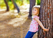 blond kid girl on autumn tree trunk blond kid girl on autumn tree trunk