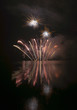 Colorful fireworks on black sky background with water reflection Colorful fireworks on black sky background with water reflection