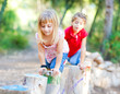 kid girls playing on trunks in forest nature kid girls playing on trunks in forest nature