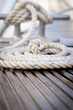 Photo: Mooring rope with a knotted end tied around a cleat on a pier. Mooring rope with a knotted end tied around a cleat on a pier.