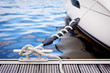 Photo: A white yacht moored with a line tied around a metal fixing A white yacht moored with a line tied around a metal fixing
