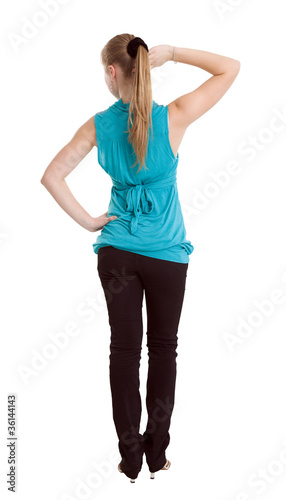 Photo: Slim girl doing a workout. View from the back Slim girl doing a workout. View from the back