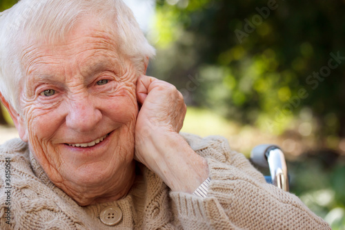 Photo: Happy senior lady in wheelchair smiling outside Happy senior lady in wheelchair smiling outside