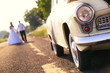 Young wedding couple walk on the road Young wedding couple walk on the road