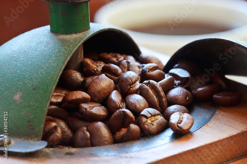 Photo: Macro shot of coffee beans in antique coffee grinder Macro shot of coffee beans in antique coffee grinder
