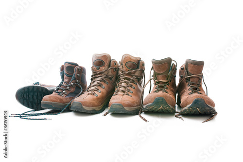 Foto: Three pairs of hiking boots. Concept for family hiking Three pairs of hiking boots. Concept for family hiking