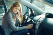 Foto: Young blue-eyed businesswoman inside her car Young blue-eyed businesswoman inside her car