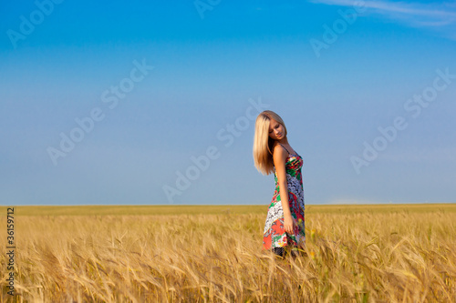 Photo: woman walking on wheat field woman walking on wheat field