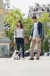 Photo: Woman holding a puppy on leash with a man standing beside her, Paris, Ile-de-France, France Woman holding a puppy on leash with a man standing beside her, Paris, Ile-de-France, France