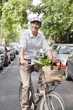 Man carrying vegetables on a bicycle, Paris, Ile-de-France, France