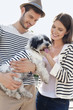 Couple carrying a puppy, Paris, Ile-de-France, France
