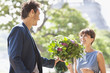 Photo: Man giving a bouquet of flowers to a woman with the Eiffel Tower in the background, Paris, Ile-de-France, France Man giving a bouquet of flowers to a woman with the Eiffel Tower in the background, Paris, Ile-de-France, France