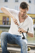 Man opening a wine bottle with a corkscrew, Paris, Ile-de-France, France