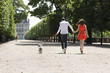 Photo: Couple running in a garden with a puppy, Terrasse De l'Orangerie, Jardin des Tuileries, Paris, Ile-de-France, France Couple running in a garden with a puppy, Terrasse De l'Orangerie, Jardin des Tuileries, Paris, Ile-de-France, France
