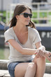 Woman sitting on the ledge of a canal, Canal St Martin, Paris, Ile-de-France, France