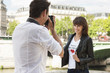 Photo: Man taking a picture of a woman with a camera, Seine River, Paris, Ile-de-France, France Man taking a picture of a woman with a camera, Seine River, Paris, Ile-de-France, France