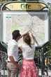 Couple pointing at a map, Paris, Ile-de-France, France