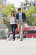 Couple walking with a puppy, Paris, Ile-de-France, France
