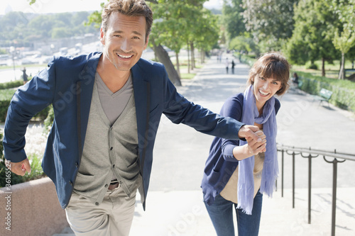 Photo: Couple moving up steps, Paris, Ile-de-France, France Couple moving up steps, Paris, Ile-de-France, France