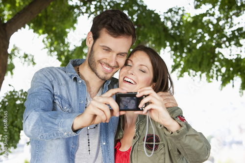 Photo: Couple taking a picture of themselves with a digital camera, Paris, Ile-de-France, France Couple taking a picture of themselves with a digital camera, Paris, Ile-de-France, France