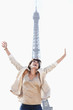 Photo: Woman shouting in excitement with the Eiffel Tower in the background, Paris, Ile-de-France, France Woman shouting in excitement with the Eiffel Tower in the background, Paris, Ile-de-France, France