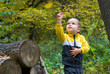 Cute boy and falling leaf