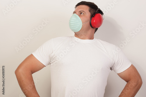 Photo: Image of a handy man with respirator and protective headphones Image of a handy man with respirator and protective headphones