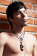 man near brick wall