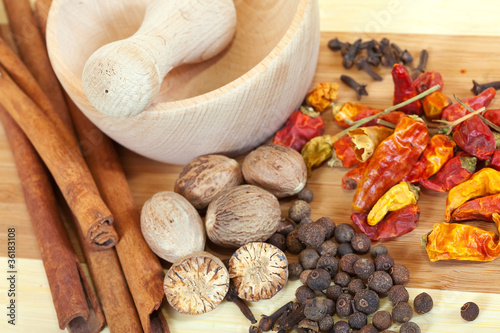 Photo: various natural spices with pestle and mortar various natural spices with pestle and mortar