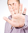 man showing his hand over gray - focus is on hand