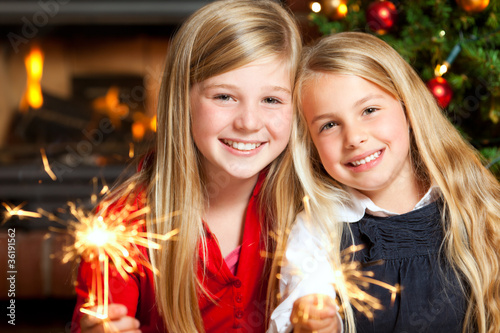 Photo: two girls with sparklers two girls with sparklers