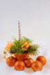 Photo: Christmas orange spheres and silver candles on the white fur Christmas orange spheres and silver candles on the white fur