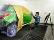 Worker painting a car.