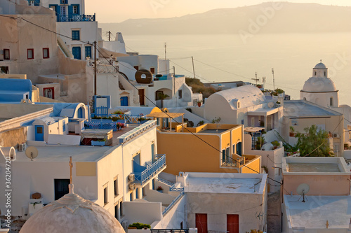 Photo: Sunset at Santorini island , Greek church with a cross Sunset at Santorini island , Greek church with a cross