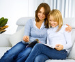 Mother with Teenage Daughter reading Magazine
