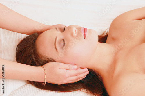 Photo: Young woman in reiki healing session Young woman in reiki healing session