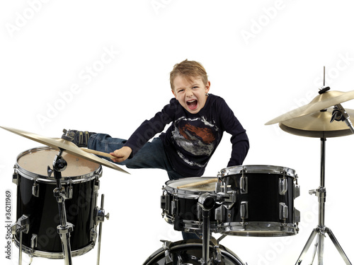 Photo: young boy play drum with energy young boy play drum with energy