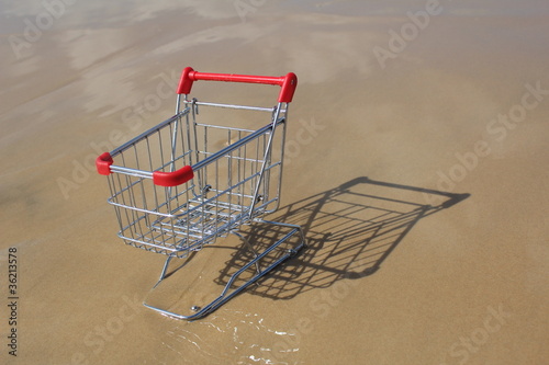 Photo: Retail cart stuck in the sand, methaphor for business challenge Retail cart stuck in the sand, methaphor for business challenge