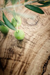 Olive branch on olive wood background