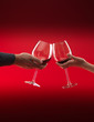 couple holding glasses of red wine toasting couple holding glasses of red wine toasting