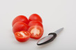 Whole and half tomatoes with knife